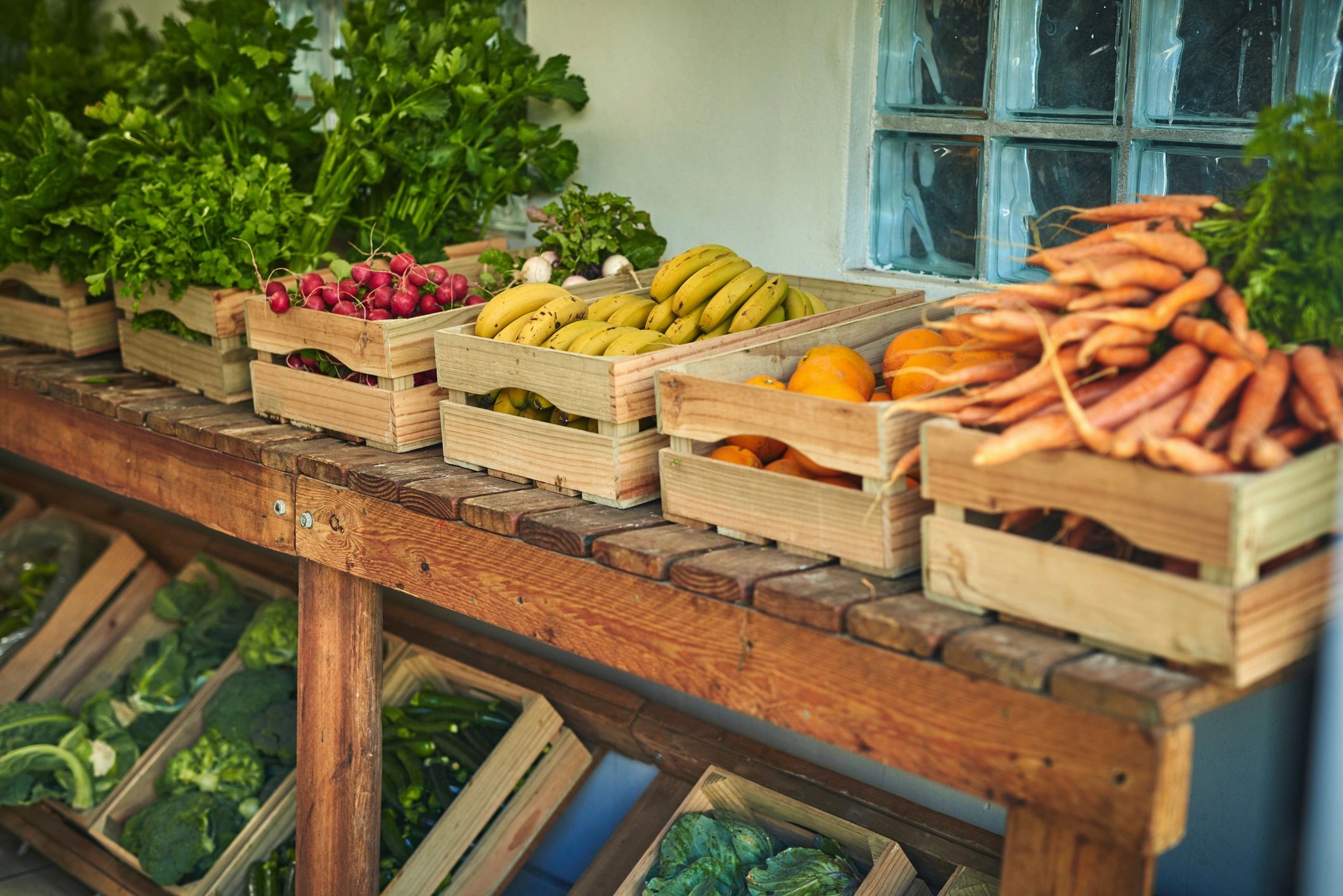 Seasonal Veggie Box — assorted colorful organic vegetables in a rustic wooden crate