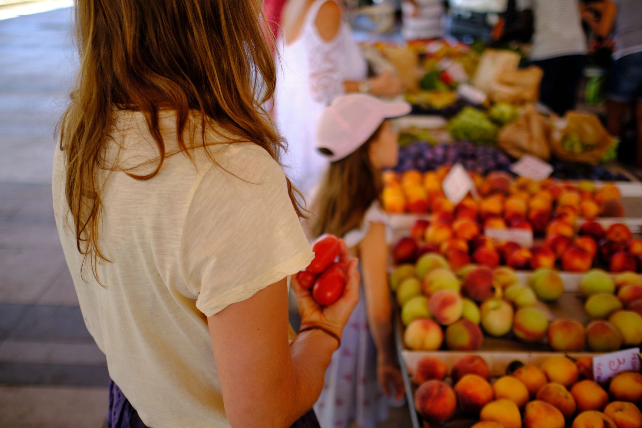 Customer buying tomatoes at an outdoor market