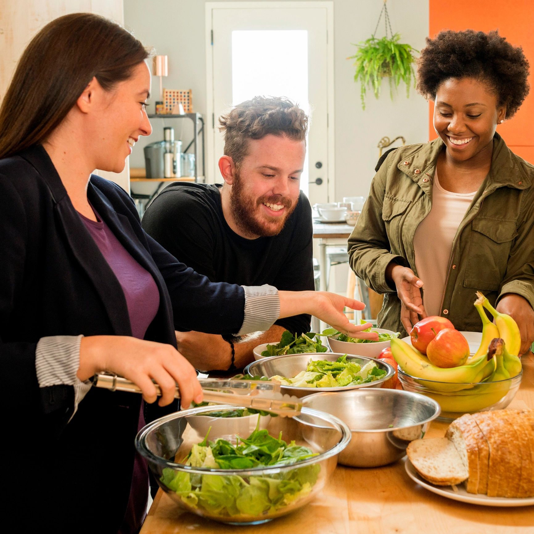 Person preparing salad in a kitchen